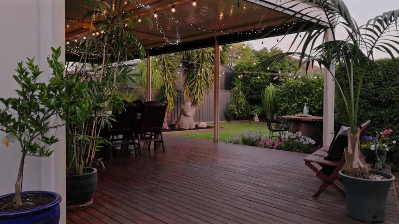 Twilight exterior of an Adelaide home with festoon lighting over the alfresco area